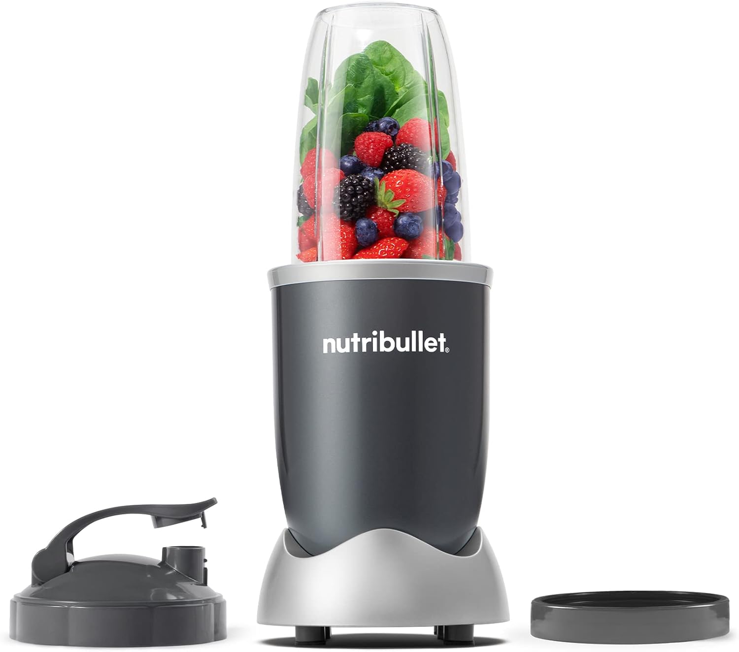 nutribullet Personal blender with a to-go cup of berries and greens beside its lid and power base