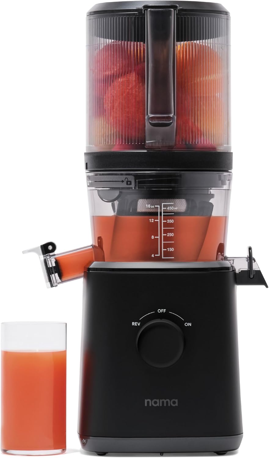 Nama J2 cold press masticating juicer beside a glass of fresh juice