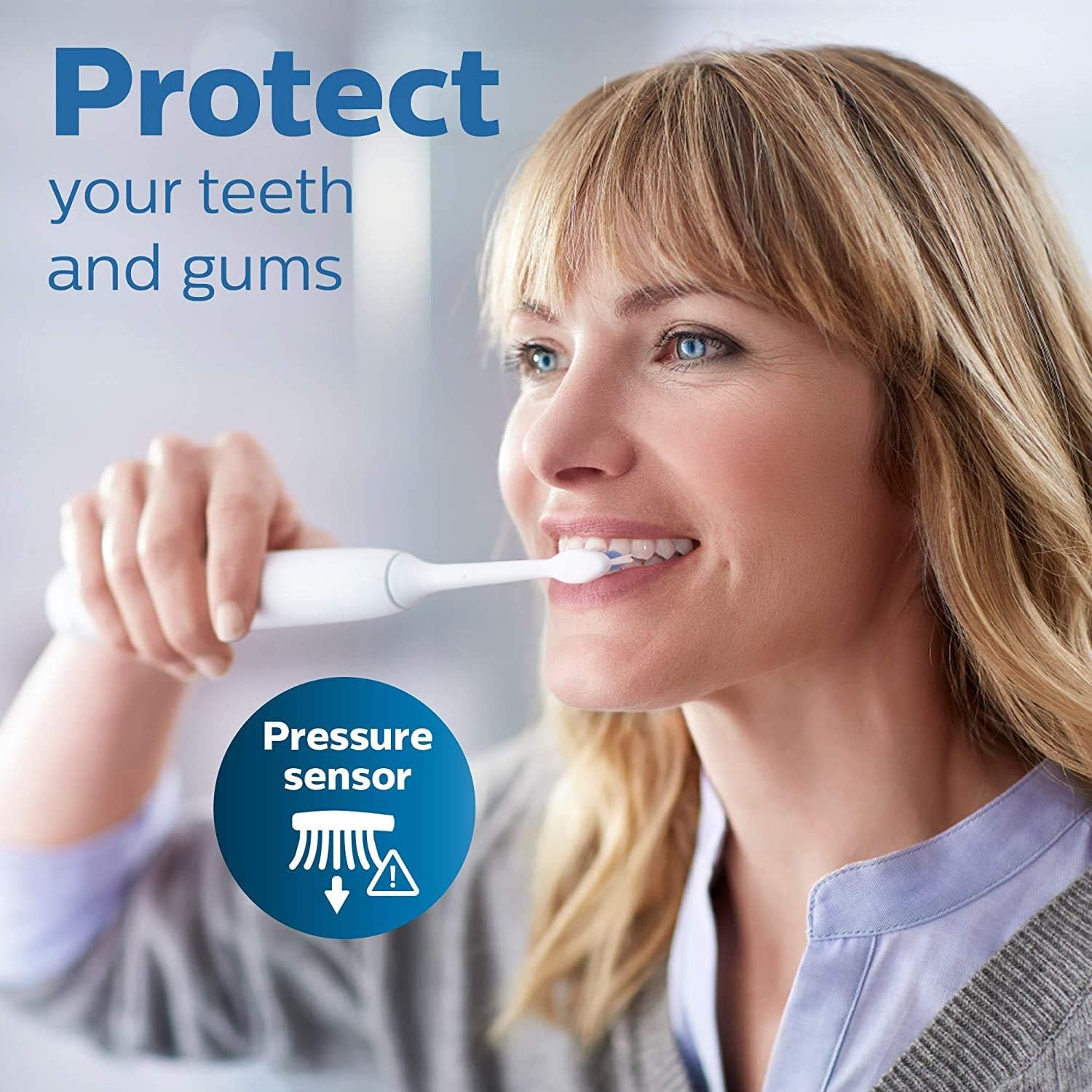 Woman brushing with a Philips Sonicare electric toothbrush that has a pressure sensor