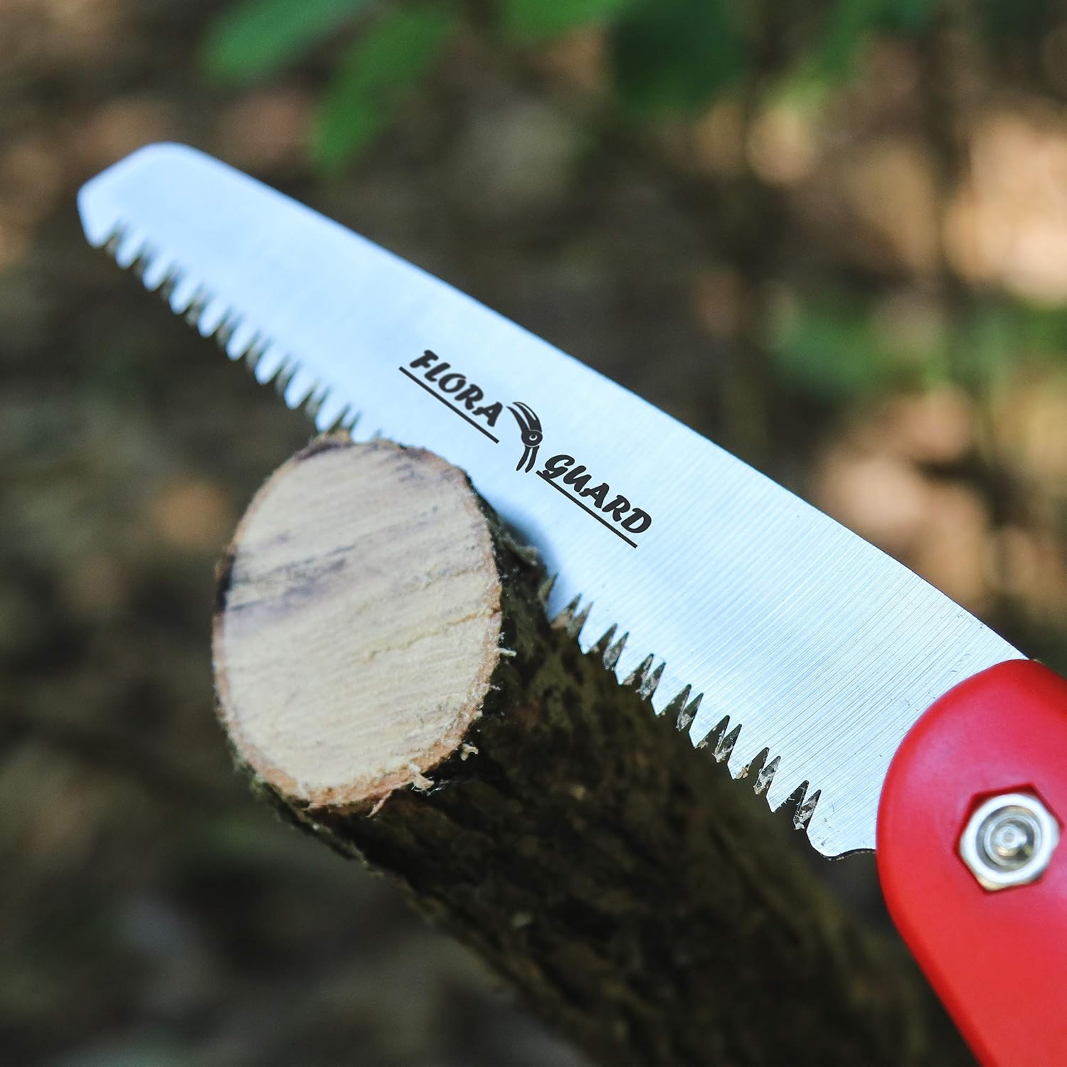 Flora Guard folding pruning saw cutting cleanly through a wooden log